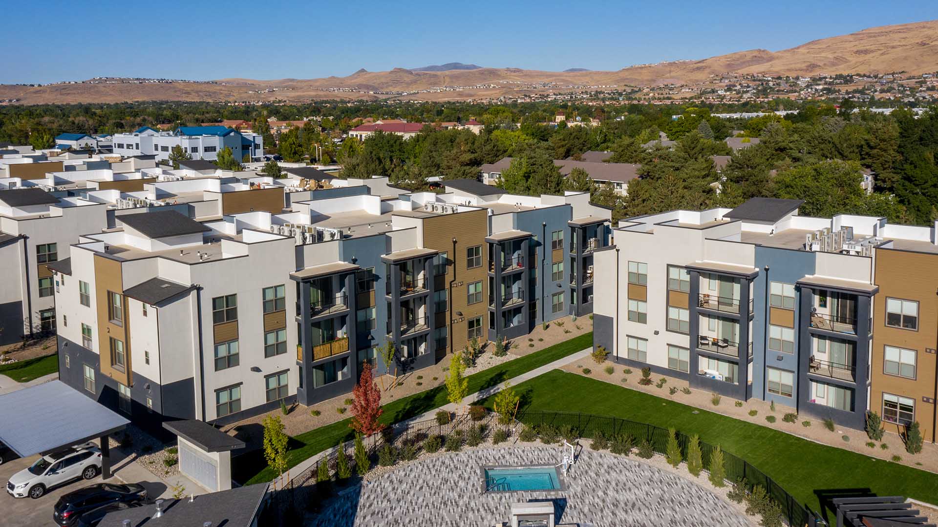 Aerial view of Azure apartments with lush landscaping and sun deck.