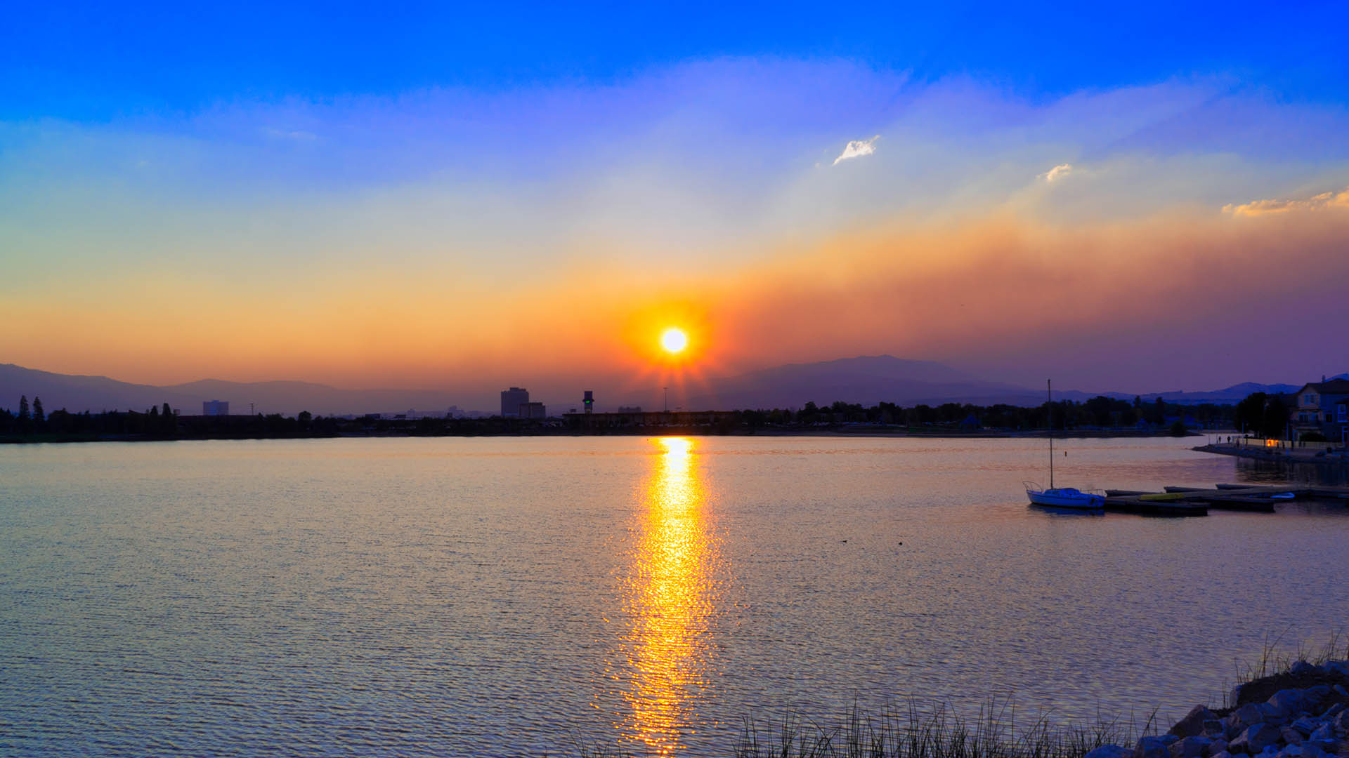 Colorful sunset over lake marina.